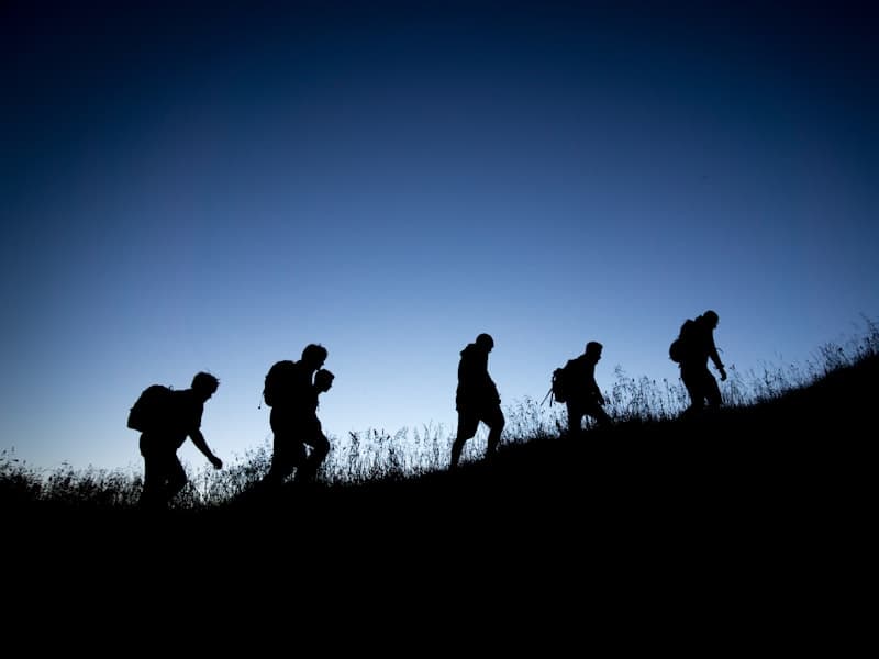 Hikers on a ridge at dusk