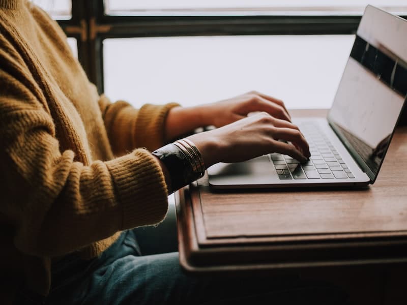 A person completing an online questionnaire on a laptop